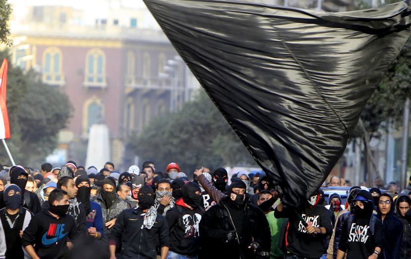 Members of the Black Bloc are seen during the protest in Tahrir Square in Cairo